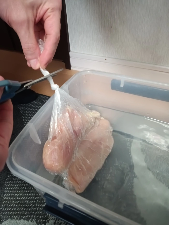 鶏むねが入った袋の余分な部分をカット